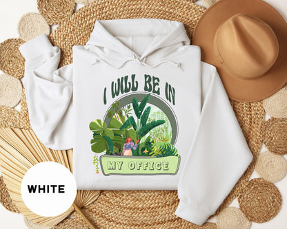 a white hoodie with the words i would be in my office printed on it