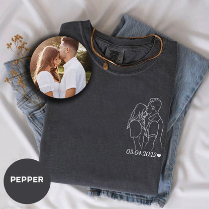 a photo of a couple on a t - shirt next to a pair of jeans