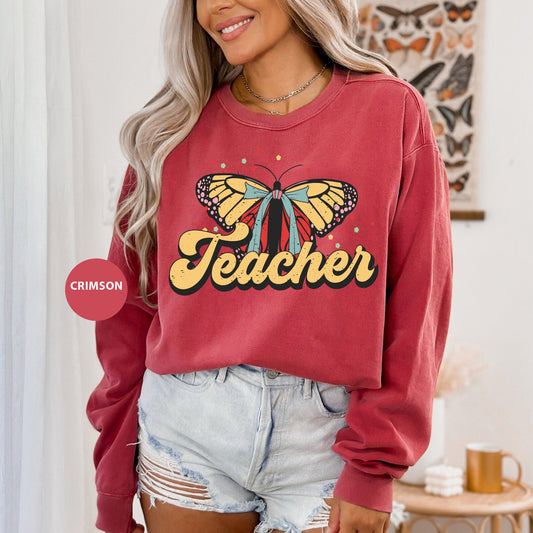 a woman wearing a red sweatshirt with a butterfly on it