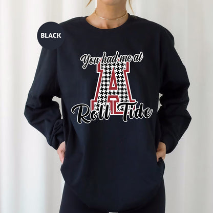 a woman wearing a black sweatshirt with the letter a on it