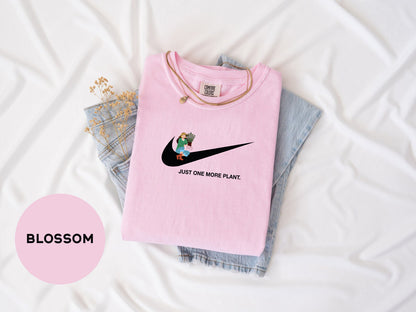 a pink shirt with a black nike logo on it