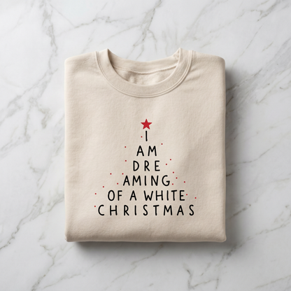 A beige t-shirt with a Christmas-themed design printed on it, featuring a tree-like shape with a red star and the text "I AM DREAMING OF A WHITE CHRISTMAS" printed on it.