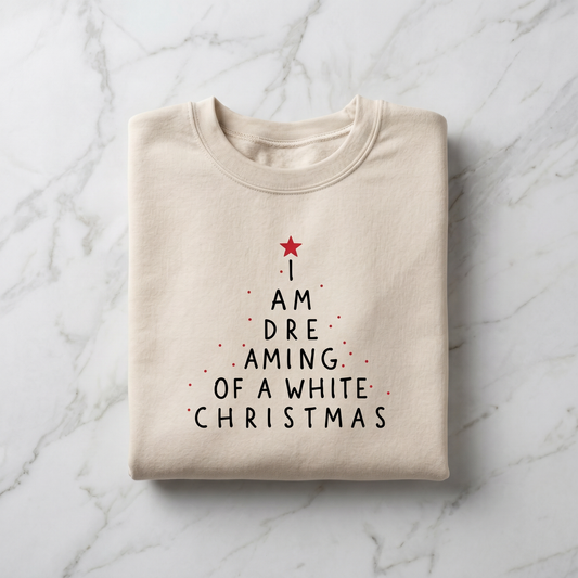 A beige t-shirt with a Christmas-themed design printed on it, featuring a tree-like shape with a red star and the text "I AM DREAMING OF A WHITE CHRISTMAS" printed on it.