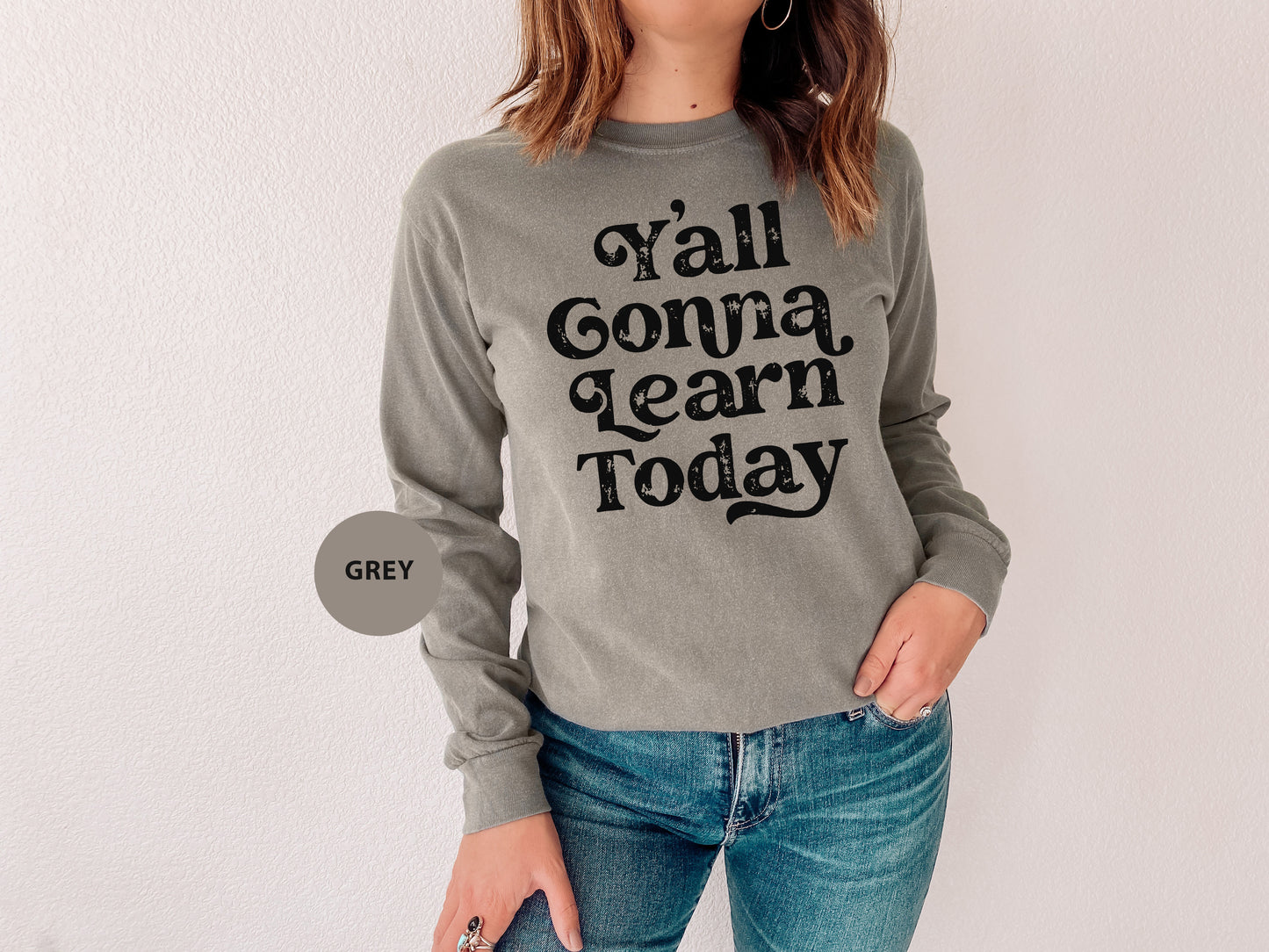 a woman wearing a sweater that says y'all gona learn today