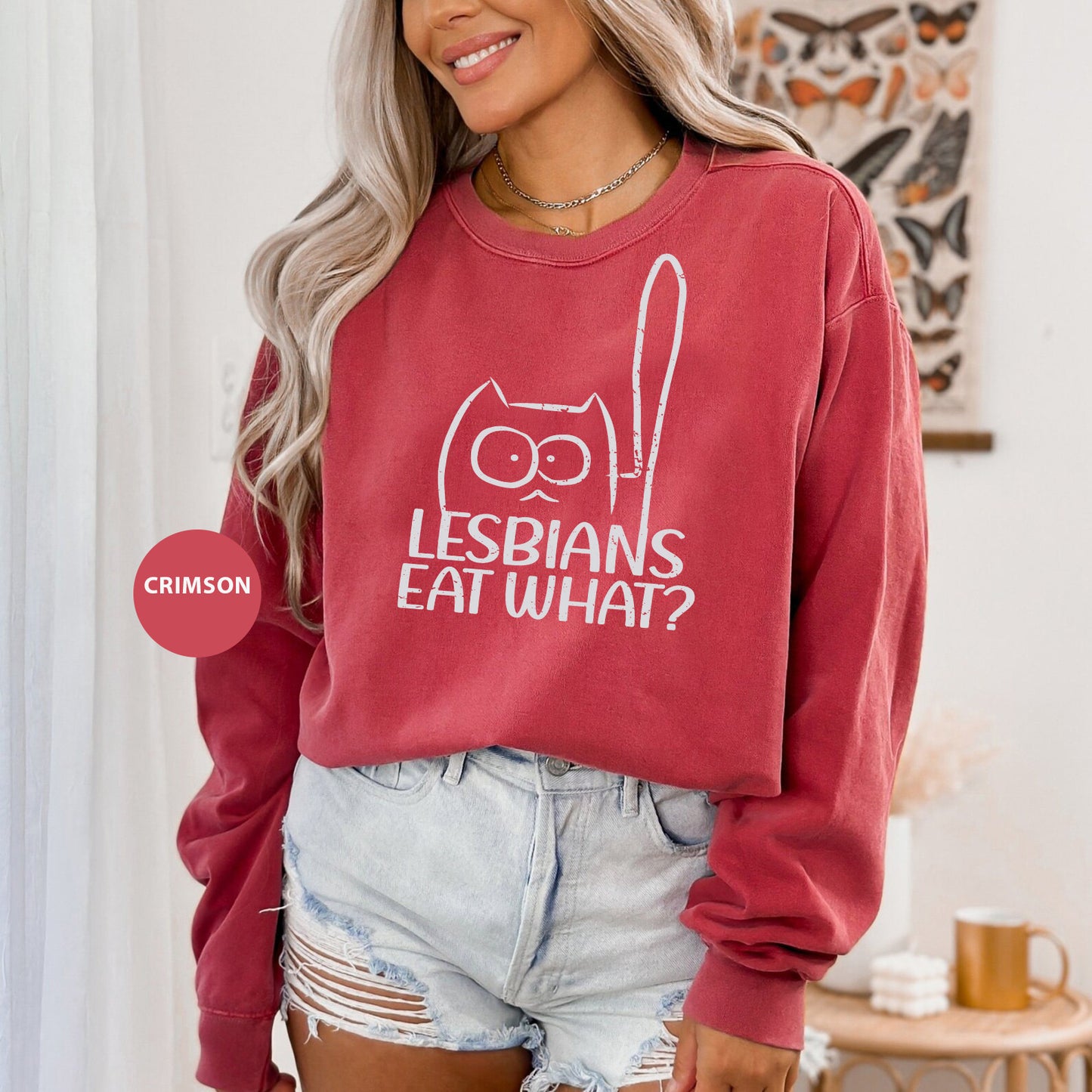 a woman wearing a red sweatshirt that says lesbians eat what?