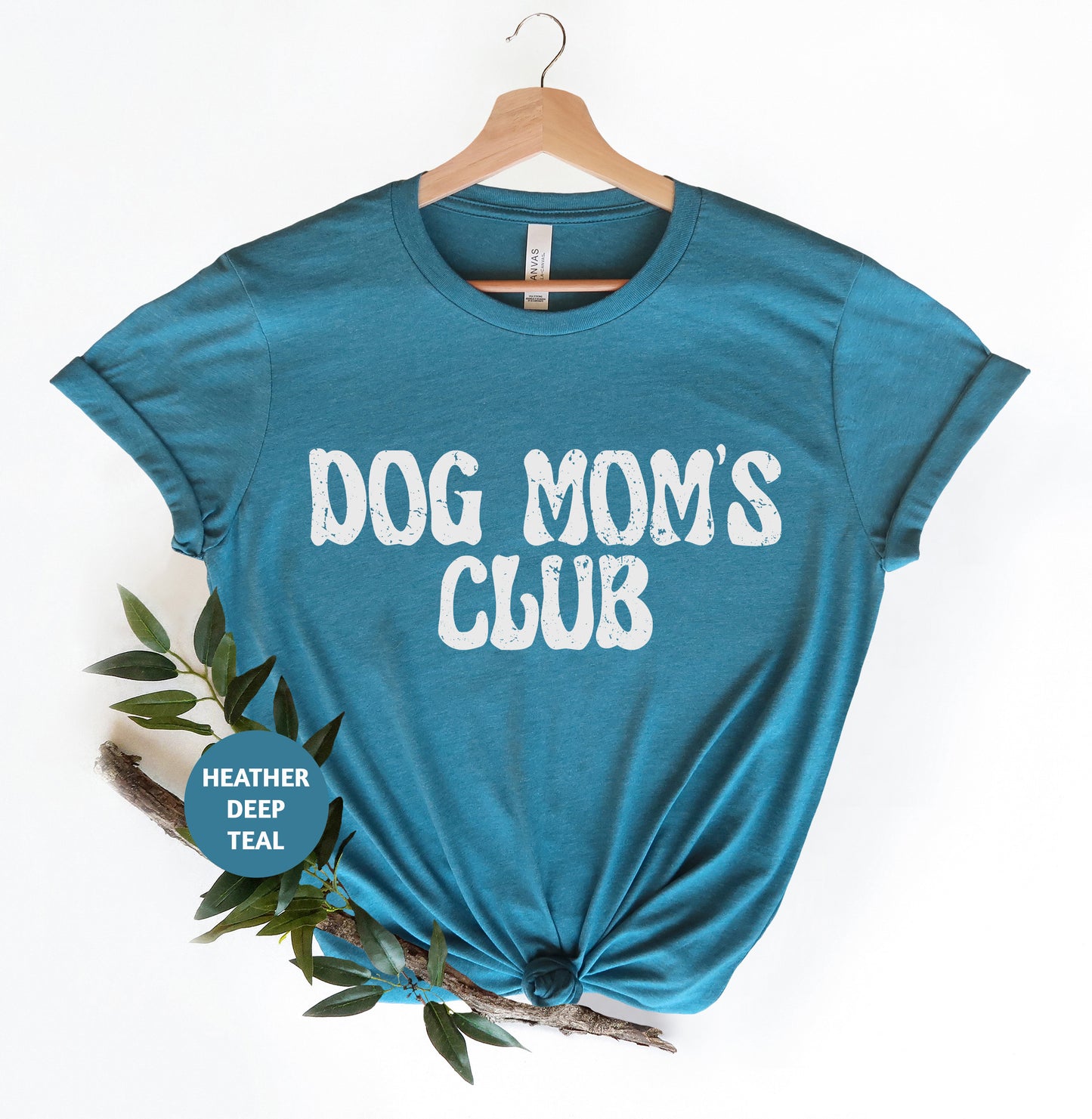 a blue dog mom's club t - shirt on a hanger