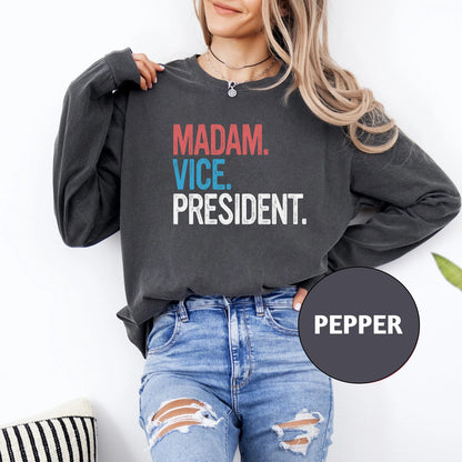 a woman wearing a sweatshirt that says madam vice president