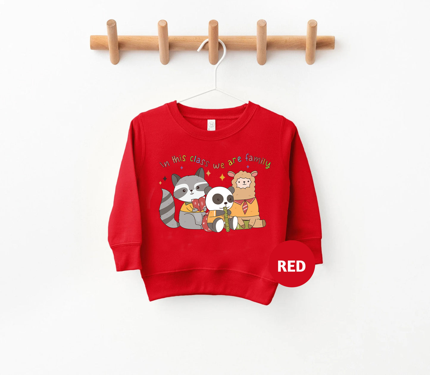 a red sweatshirt hanging on a wooden hanger