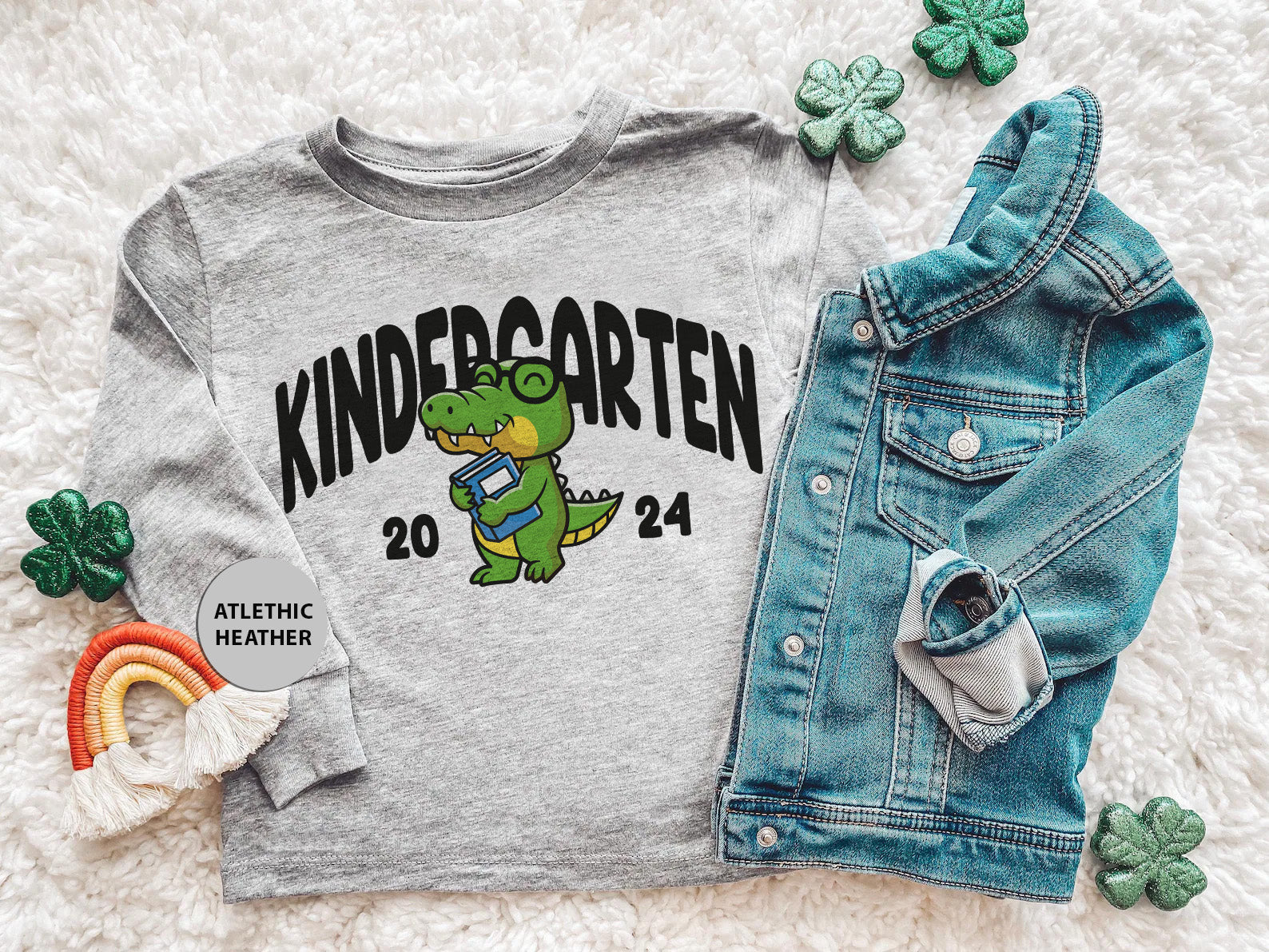 a shirt that says kindergarten next to a pair of jeans and a