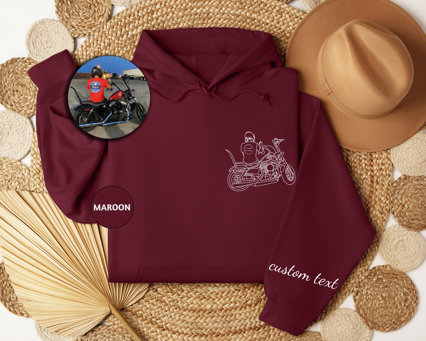 a maroon hoodie with a picture of a man riding a motorcycle