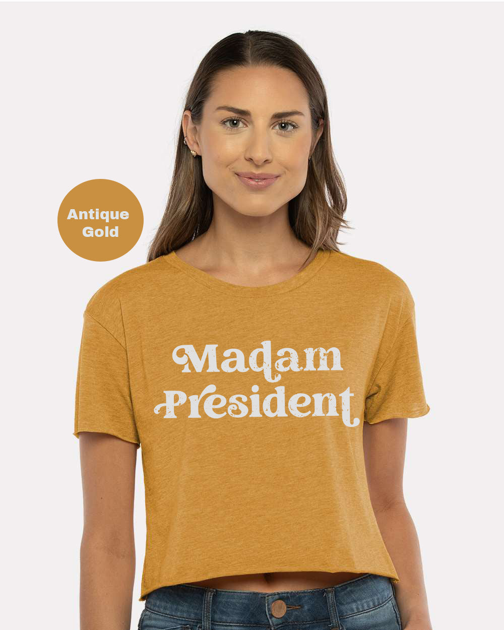 a woman wearing a mustard colored shirt that says madam president