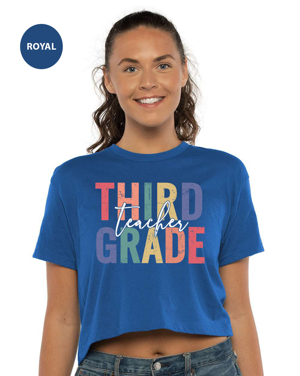 a woman wearing a blue shirt that says third grade