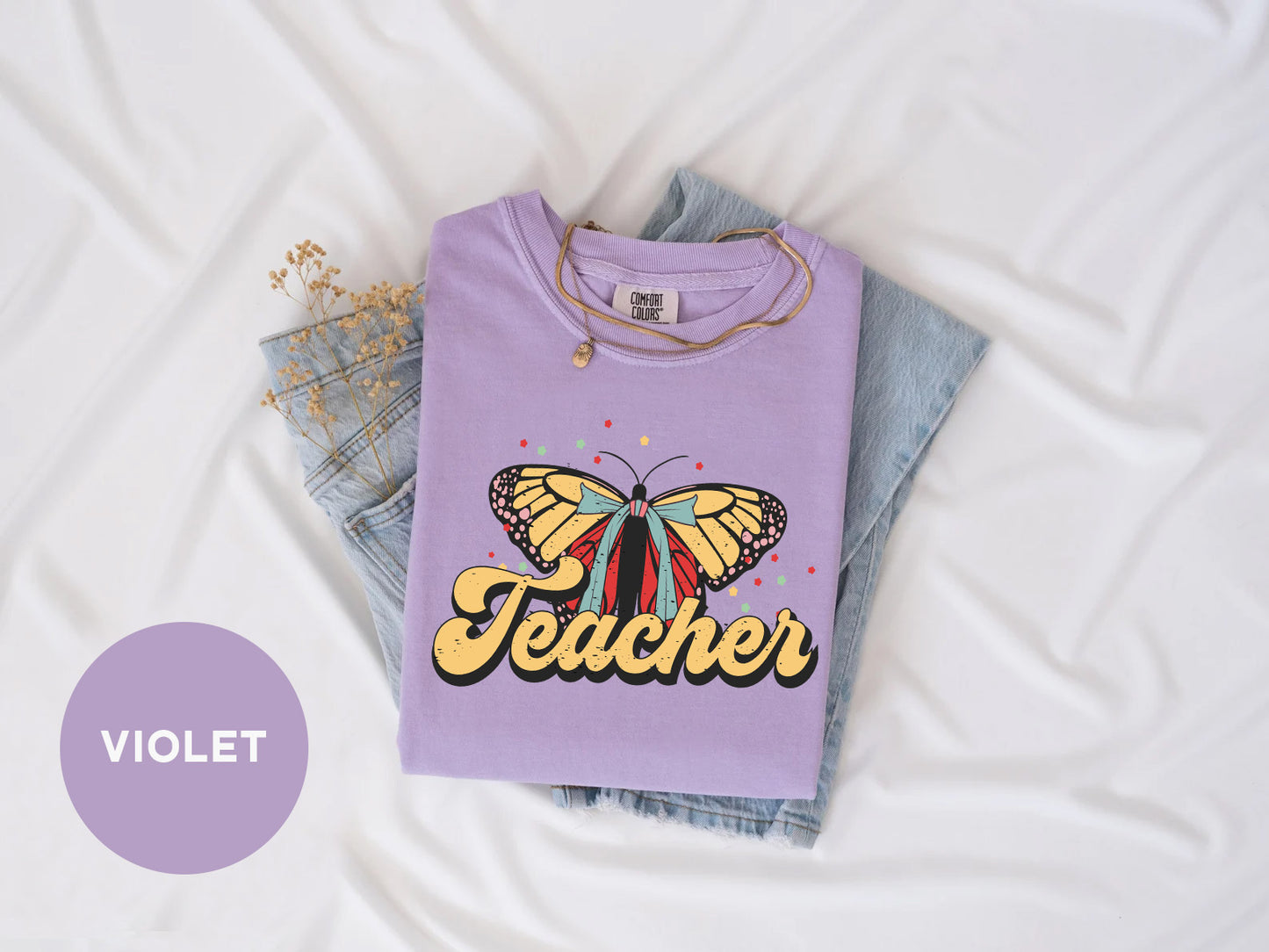 a purple shirt with a butterfly on it