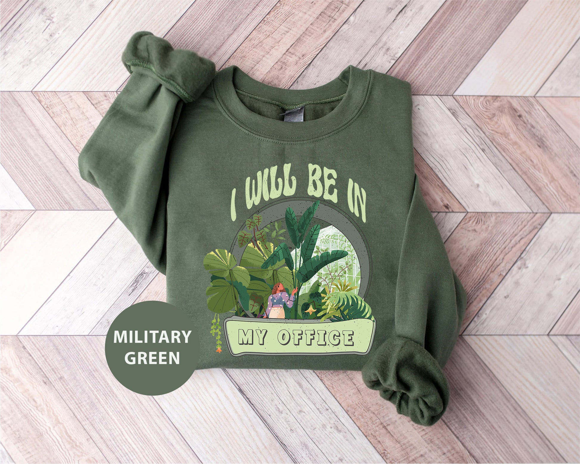 a green sweatshirt with a picture of a jungle