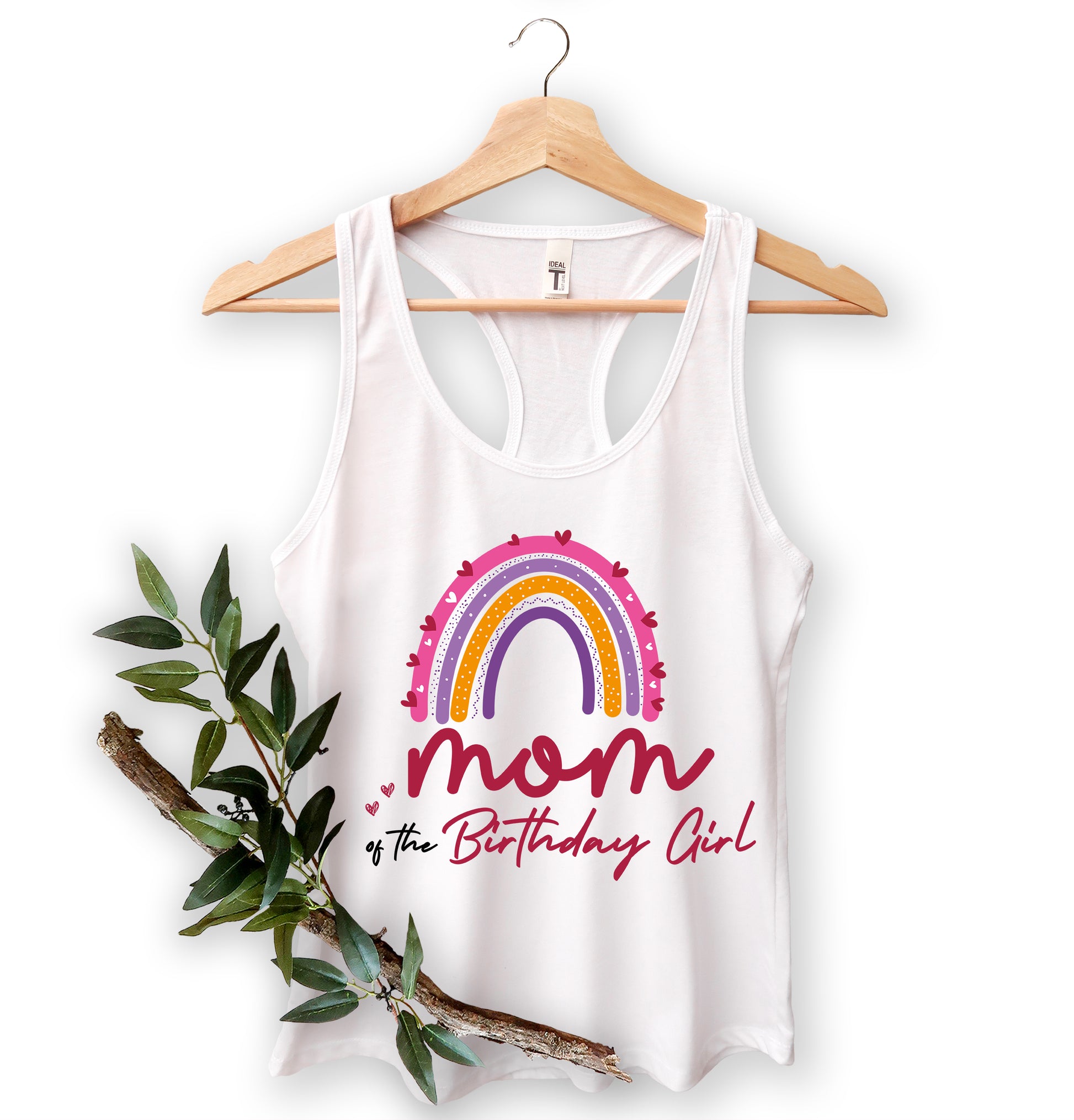 A white tank top with a colorful graphic design and text, hanging on a wooden hanger.