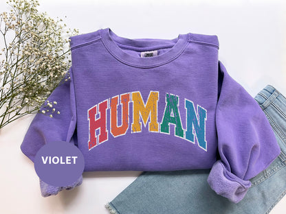 a purple shirt with the word human on it