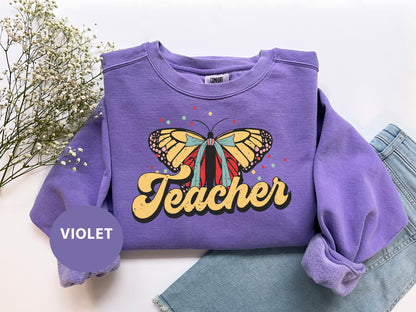 a purple sweatshirt with a butterfly on it