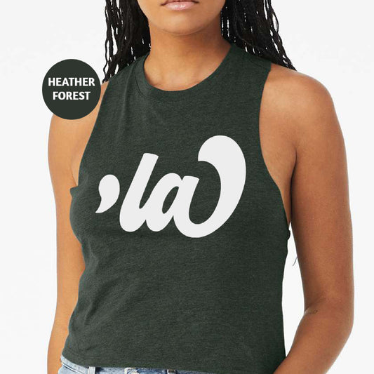 a woman wearing a green tank top with white letters