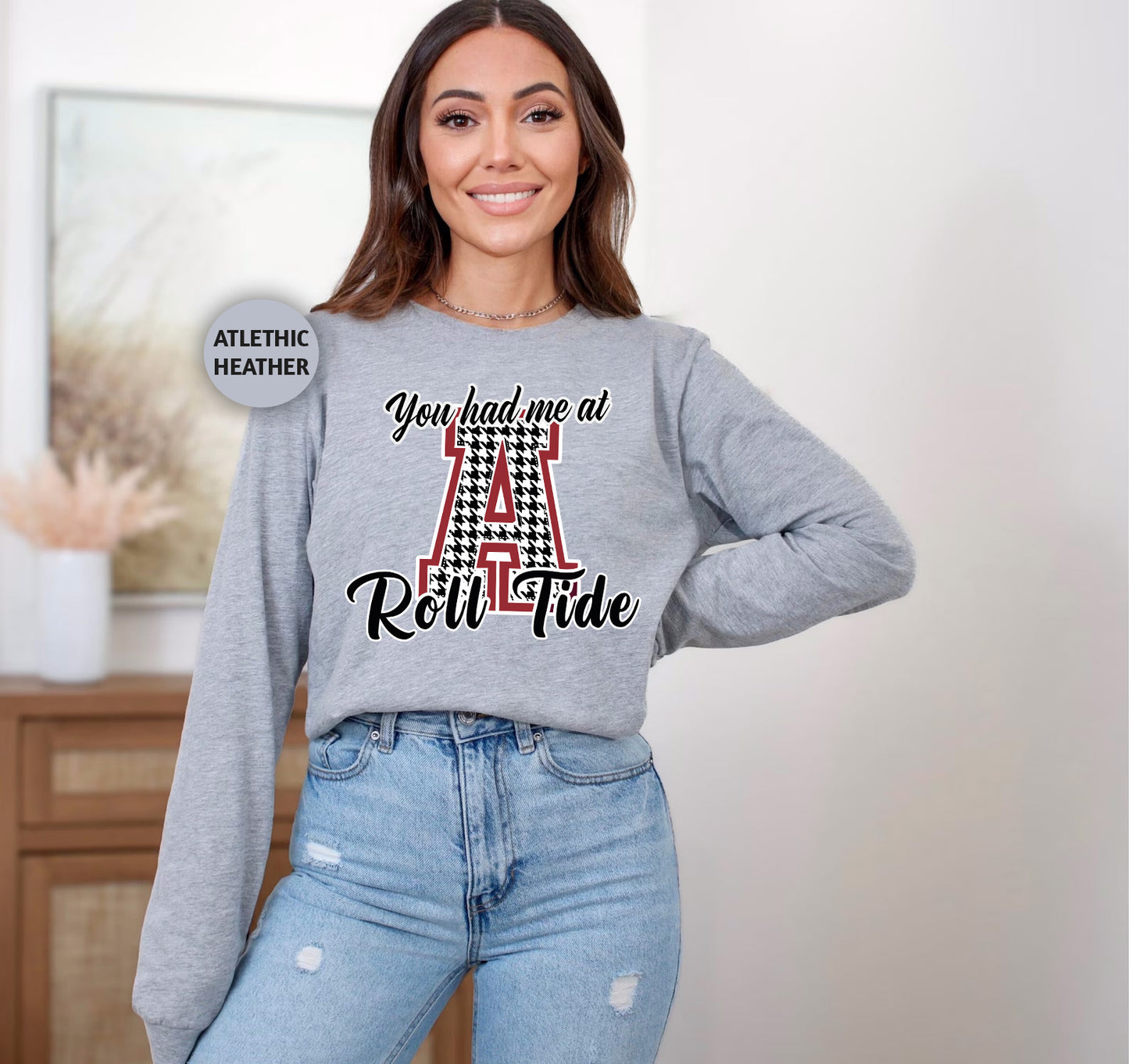 a woman wearing a sweatshirt with the letter a on it