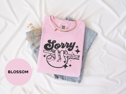 a pink shirt that says sorry on it