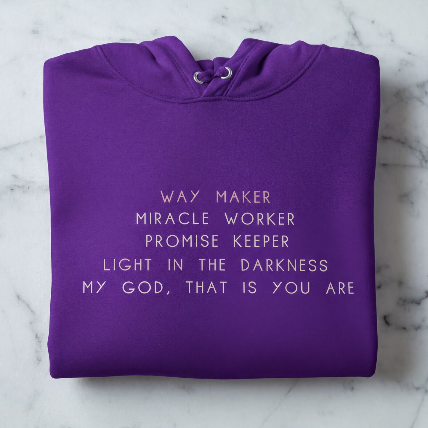 A purple hoodie with white text printed on it.