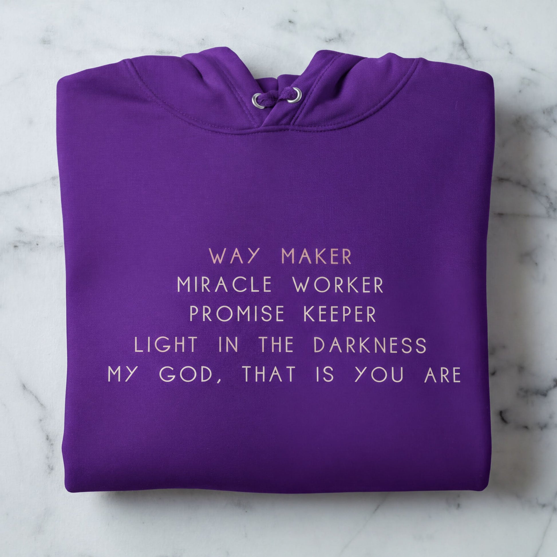 A purple hoodie with white text printed on it.