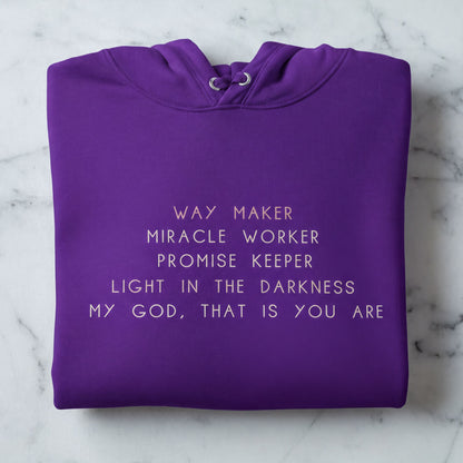 A purple hoodie with white text printed on it.
