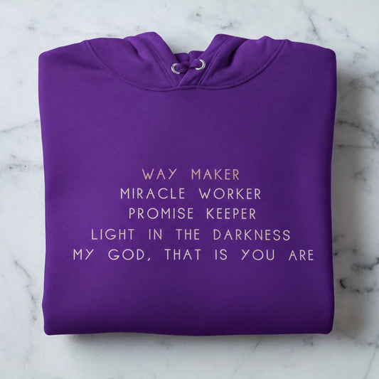 A purple hoodie with white text printed on it.