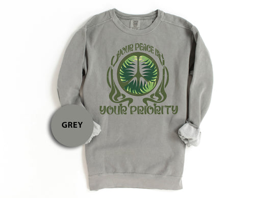 a grey sweatshirt with a green tree on it