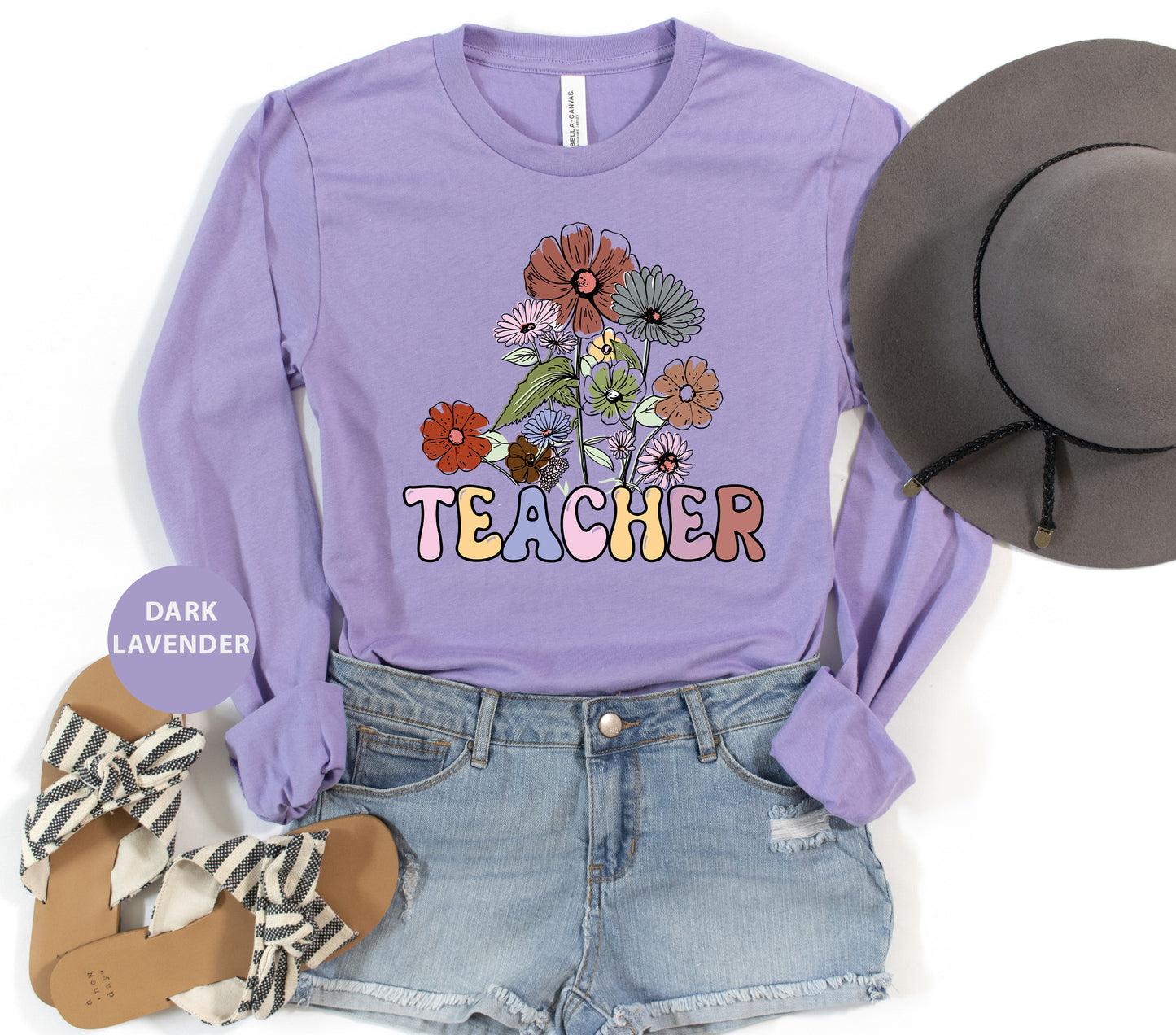 a purple shirt that says teacher with flowers on it