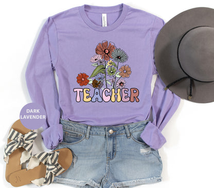 a purple shirt that says teacher with flowers on it