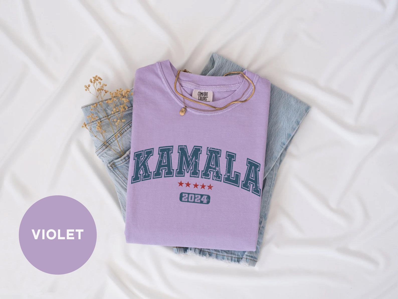 a purple shirt with the word kalamal on it next to a pair of jeans