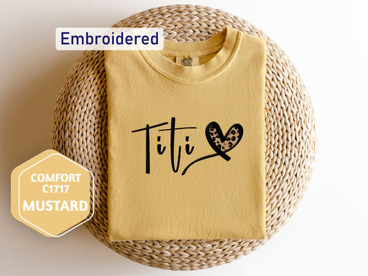 a t - shirt with the word tit on it next to a wicker