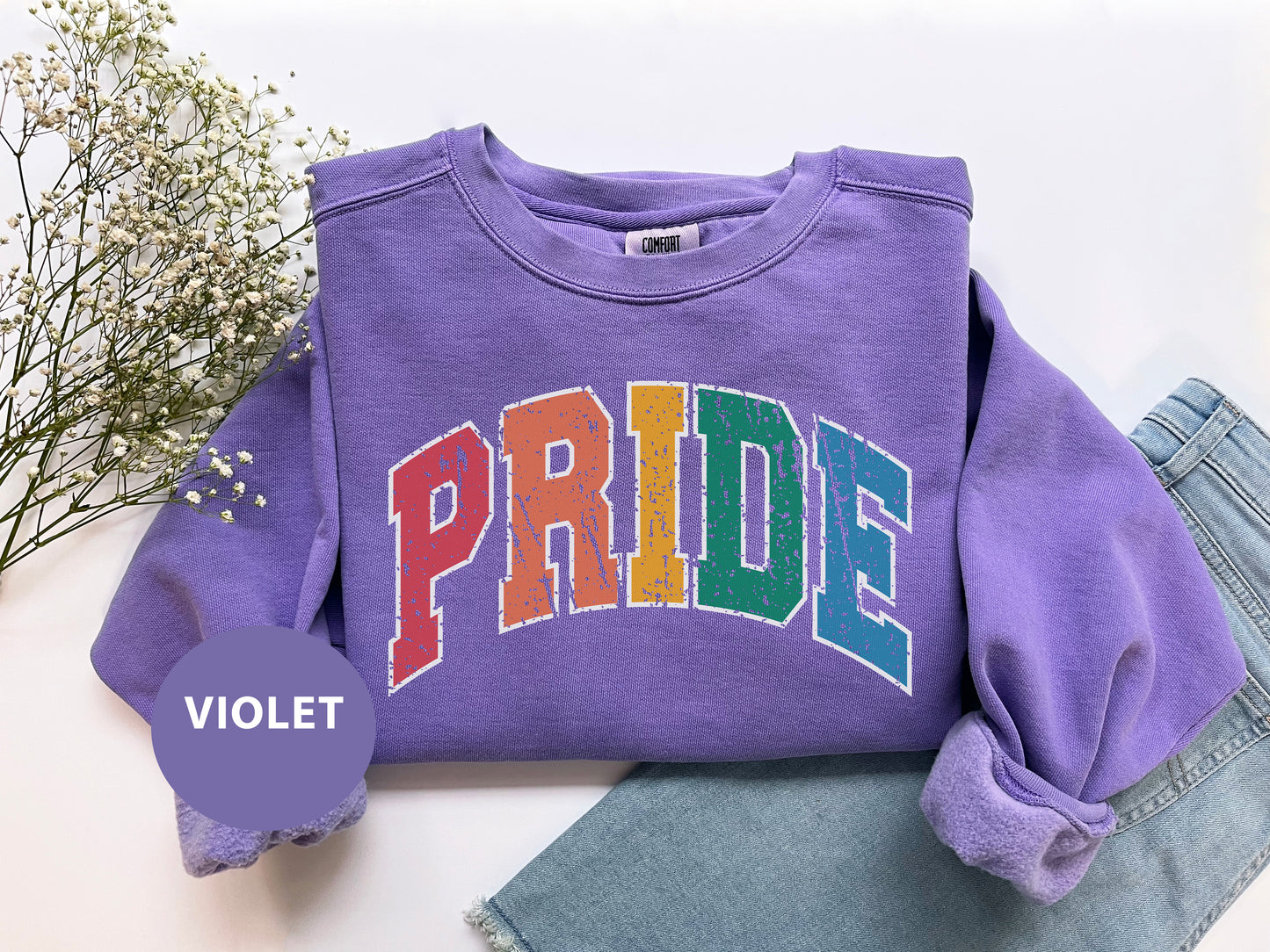 a purple sweatshirt with the word pride on it