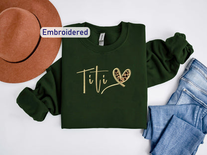 a t - shirt with the word tif on it next to a hat and