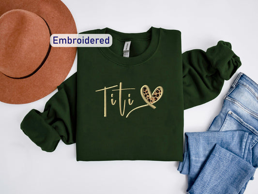 a t - shirt with the word tif on it next to a hat and