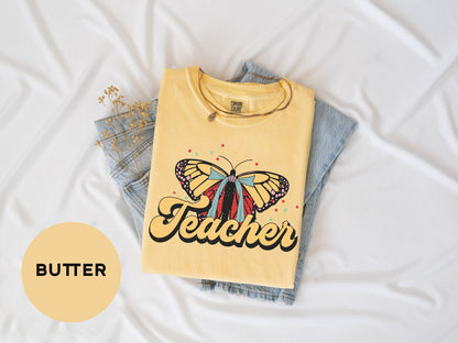 a yellow shirt with a butterfly on it