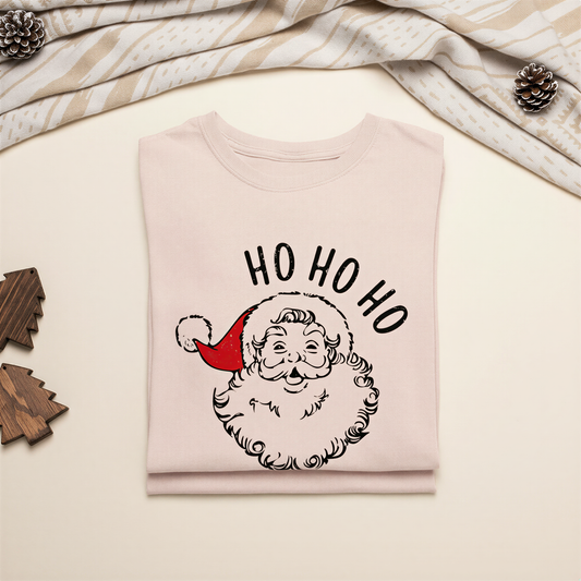 A white t-shirt with a graphic of a smiling Santa Claus wearing a red hat and the text "HO HO HO" printed on it.