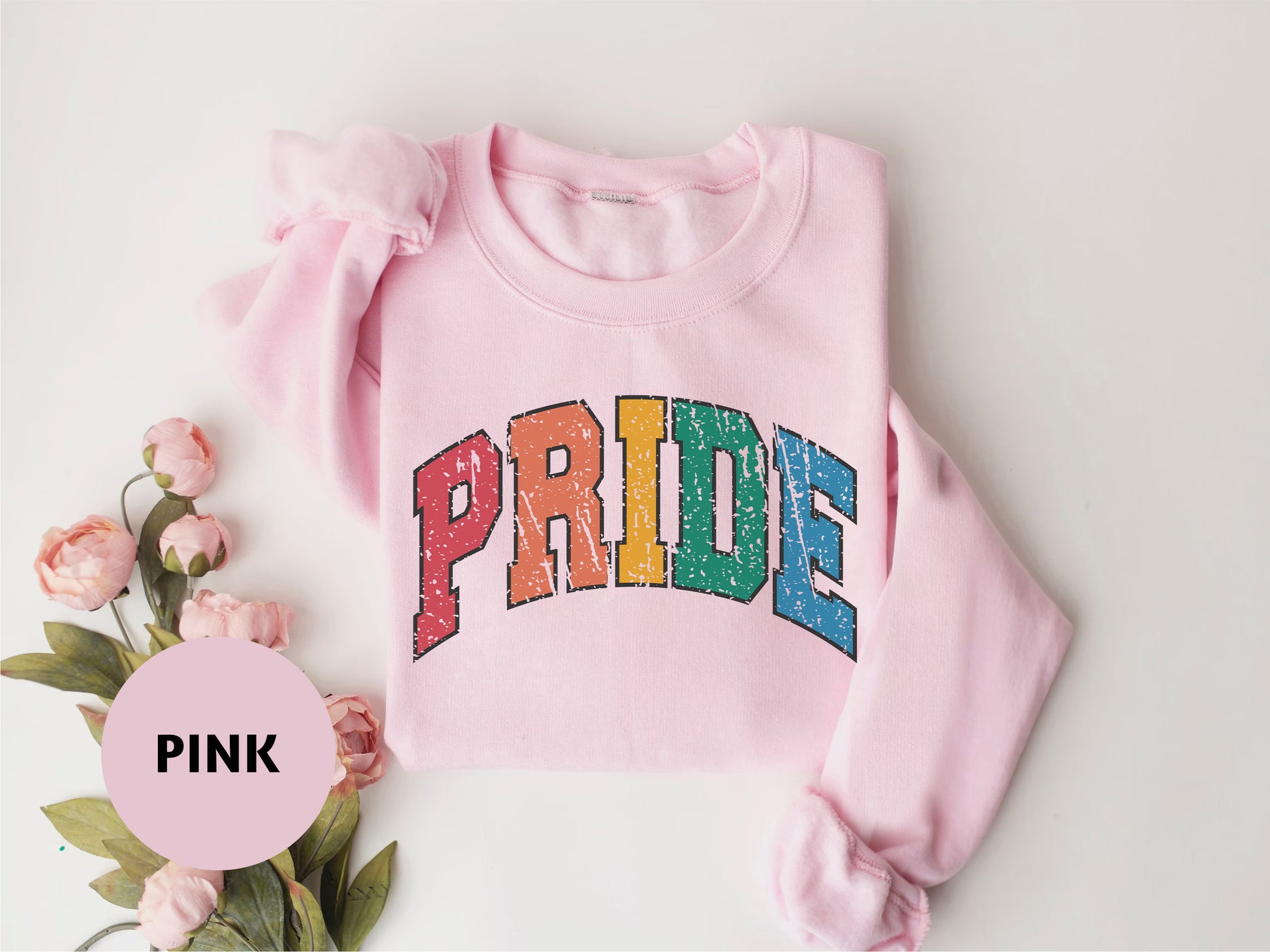 a pink sweatshirt with the word pride printed on it