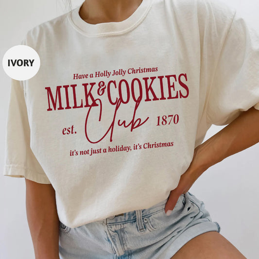 a woman wearing a white shirt that says milk and cookies