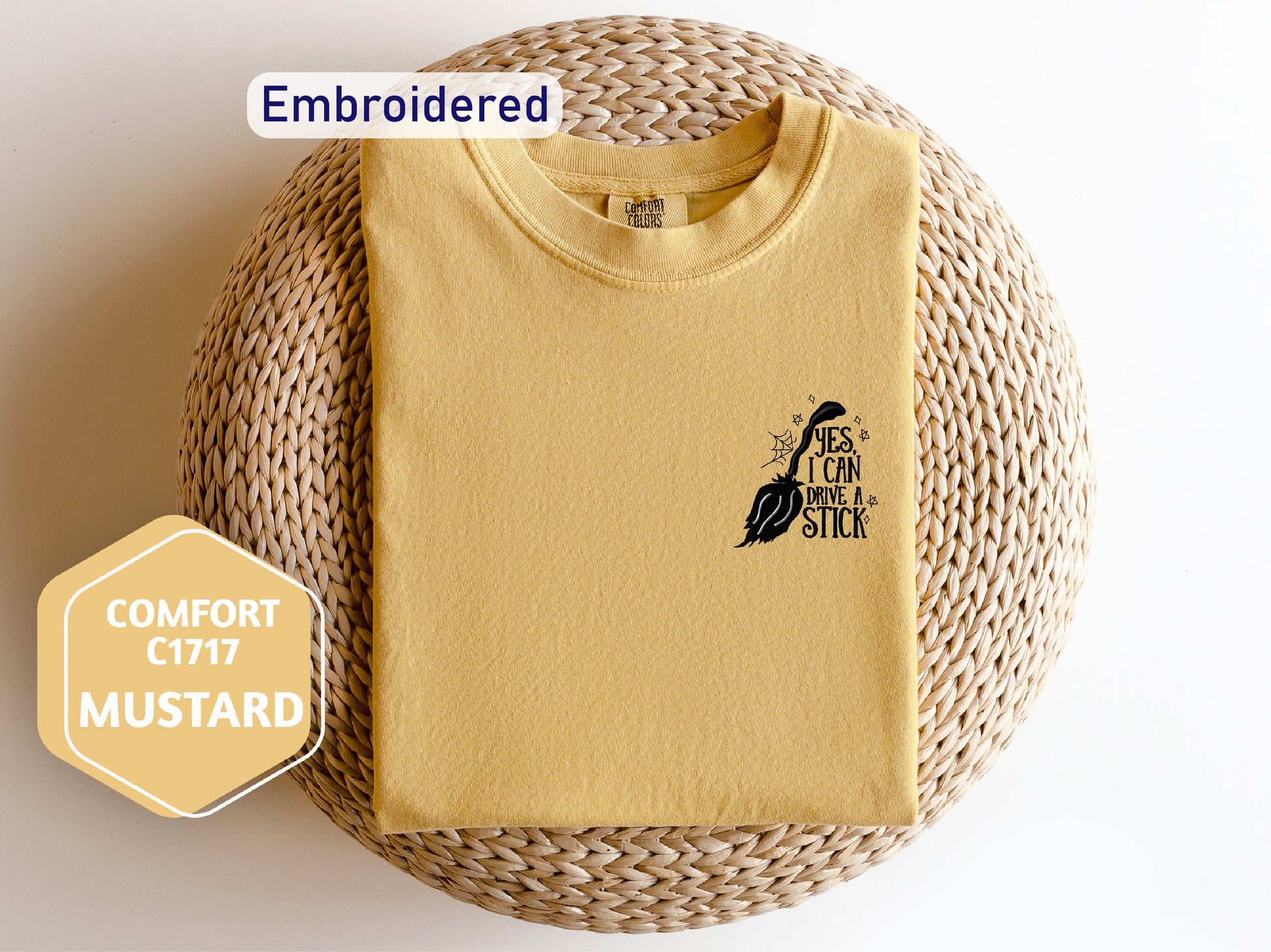 a yellow t - shirt with a bird embroidered on it