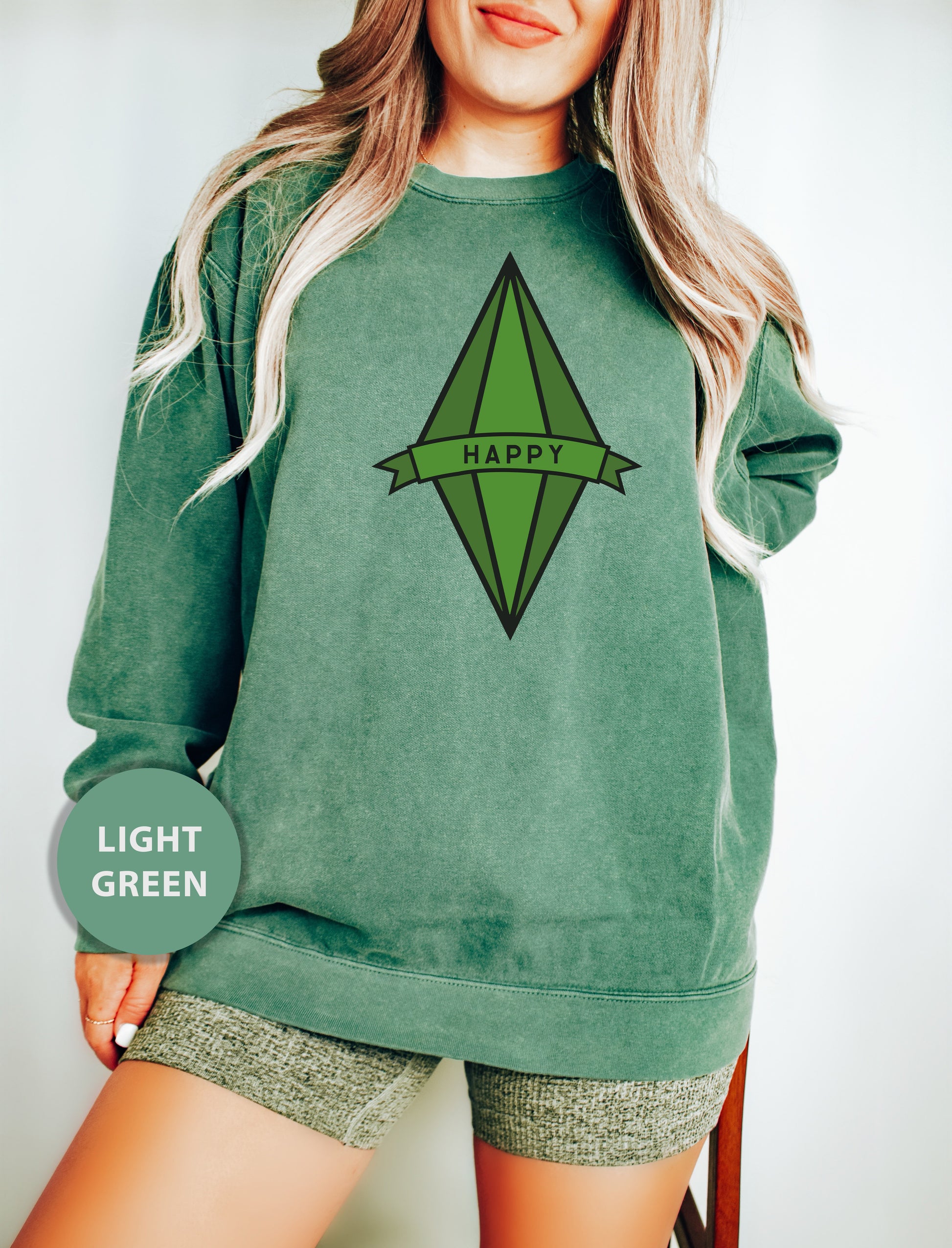 a woman wearing a green sweatshirt with the words happy on it