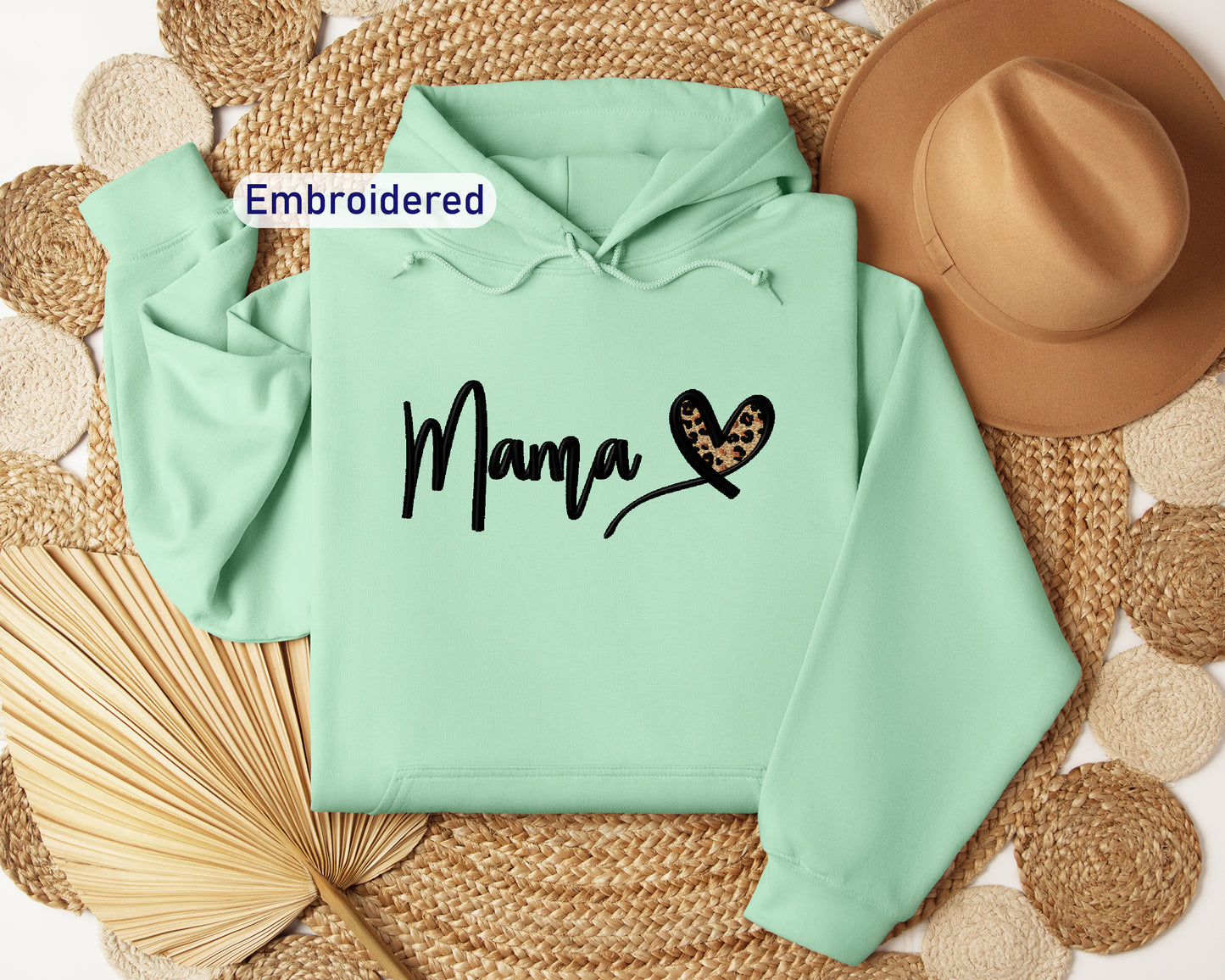 a green hoodie with the word mama printed on it