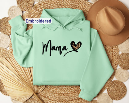 a green hoodie with the word mama printed on it