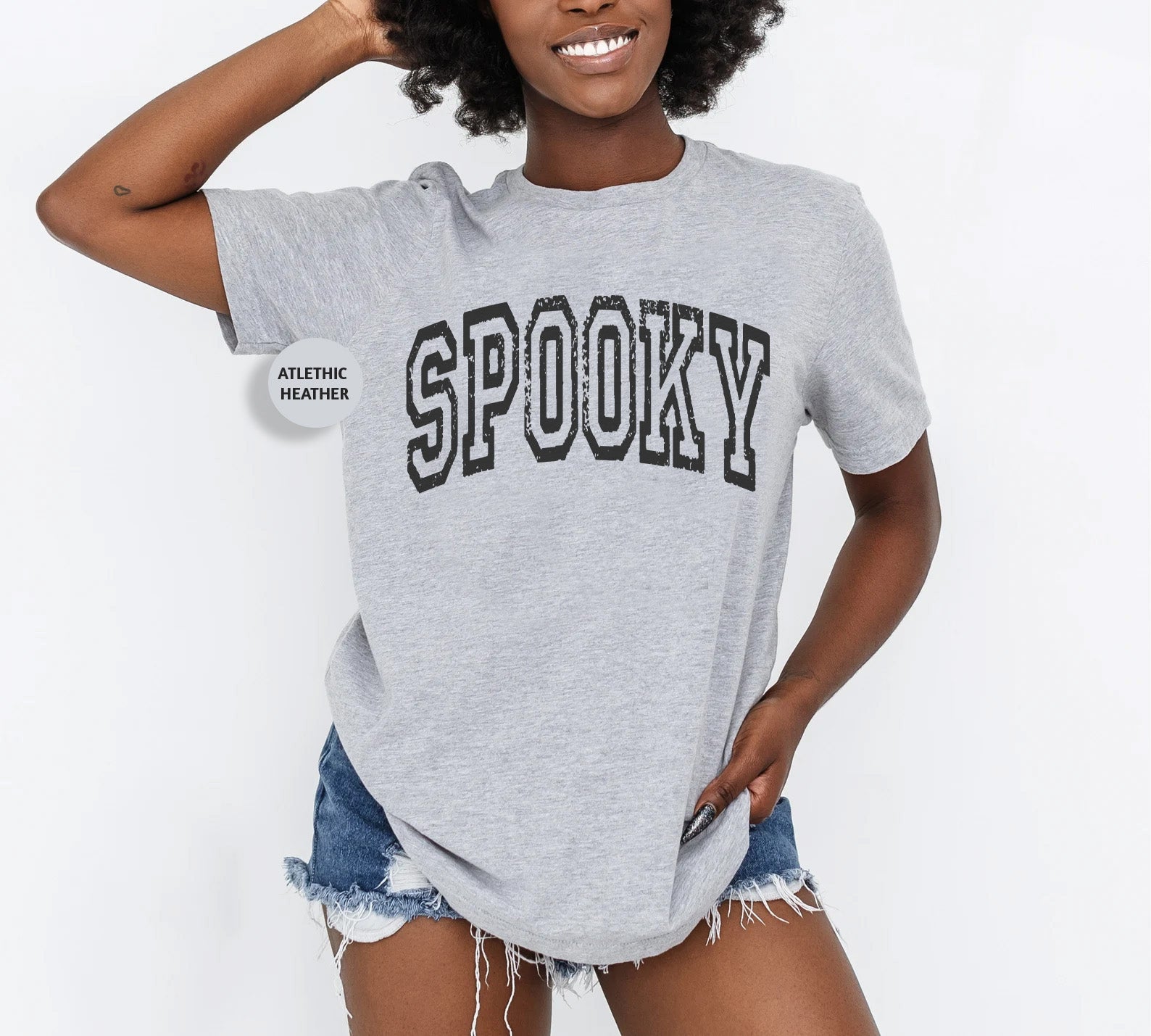 a woman wearing a grey shirt with the word spooky on it