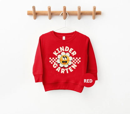 a red sweatshirt hanging on a wooden hanger