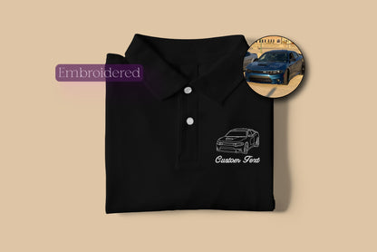 a black polo shirt with a picture of a car on it