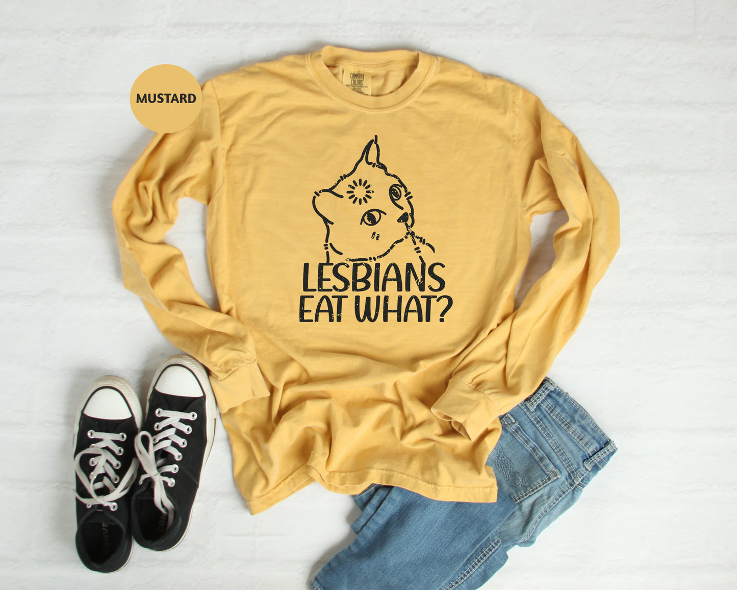 a t - shirt that says lesbians eat what? next to a pair of