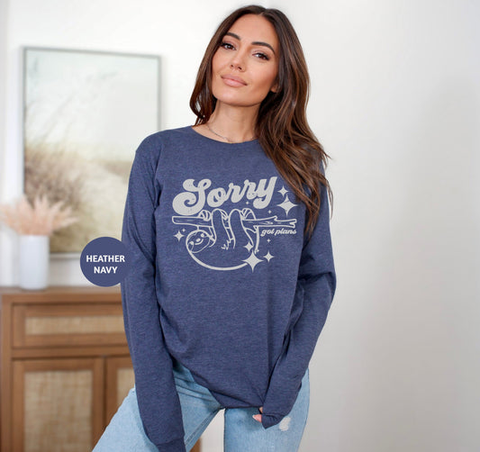 a woman standing in a room wearing a blue sweatshirt