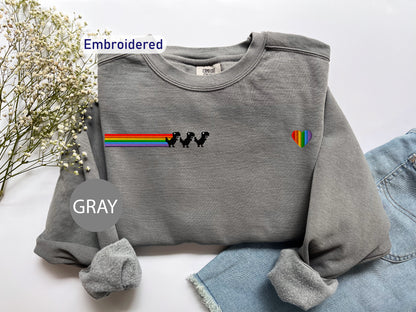 a gray shirt with a rainbow on it